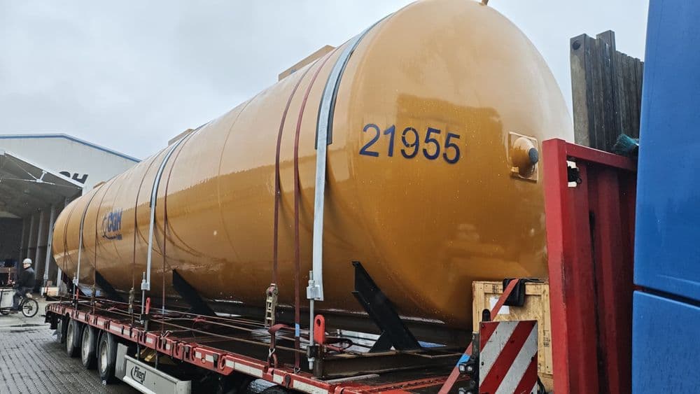 Silo secured on steel saddles with lashing straps and steel tension bands on a semi-low loader